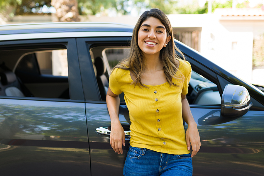 Girl standing next to car